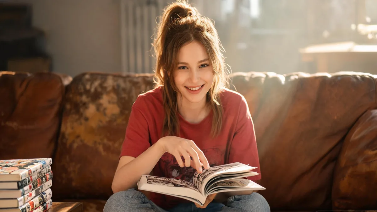 Shonen anime fan smiling in a cozy living room with shelves of figurines, the kind of fandom culture that grew around the action-packed style